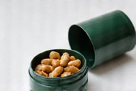 Natural vitamins for men product opened to show capsules